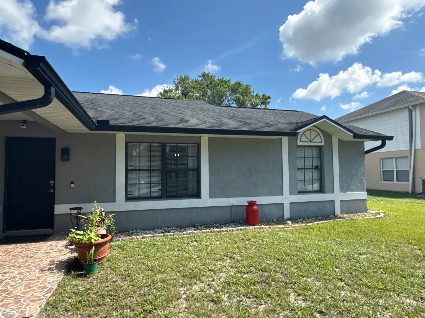 Deltona front: original dark-framed windows